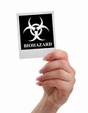 hand holding biohazard warning