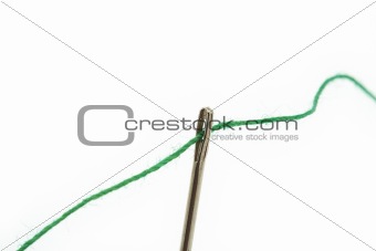 threaded needle on white
