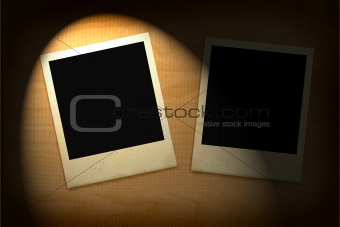 two old photo frames lit in darkness