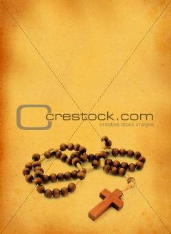 wooden rosary against retro background