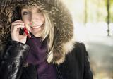 Young blond happy woman on the phone outdoors