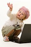 Adorable baby with laptop