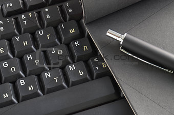 Workplace keyboard, notebook, pen,