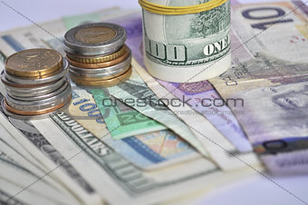 Euro coins and banknotes on white background