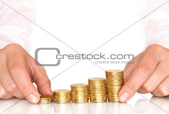 Hand putting a coin isolated on a blue background