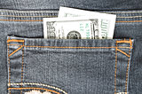 One hundred dollars in the back pocket of your jeans. Closeup.