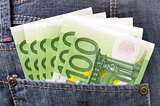 Euro banknotes in pocket of blue jeans trousers.