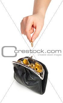 Hand throwing coin in purse on white background