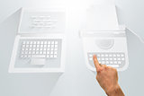 Hand pointing against laptop and typewriter