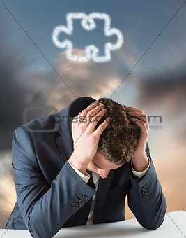 Composite image of businessman with head in hands
