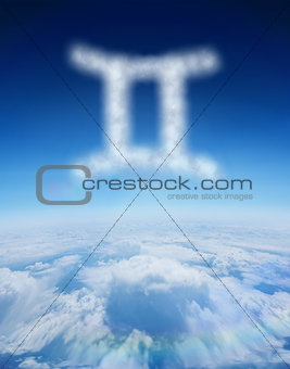 Composite image of cloud in shape of gemini star sign