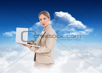 Composite image of businesswoman with a laptop
