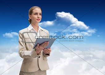 Composite image of pensive stylish businesswoman holding tablet