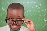 Composite image of cute pupil tilting glasses