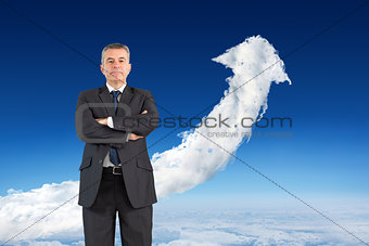 Composite image of mature businessman looking at camera