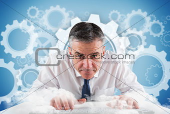 Composite image of mature businessman typing on keyboard