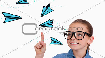 Composite image of cute pupil pointing