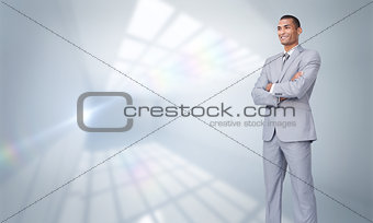 Composite image of charismatic attractive businessman with folded arms