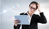 Composite image of thinking businesswoman looking at tablet pc