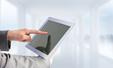 Composite image of businesswoman using a tablet pc