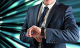 Composite image of businessman checking the time on watch