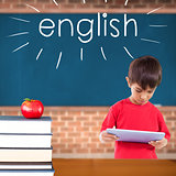 English against red apple on pile of books in classroom