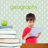 Geography against red apple on pile of books