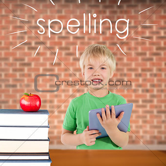 Spelling against red apple on pile of books
