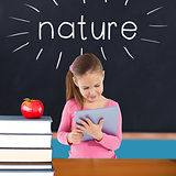Nature against red apple on pile of books in classroom