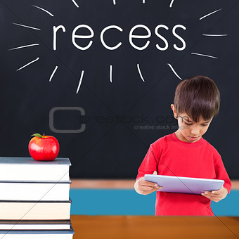 Recess against red apple on pile of books in classroom