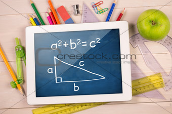 Composite image of digital tablet on students desk