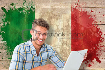 Composite image of young student using laptop