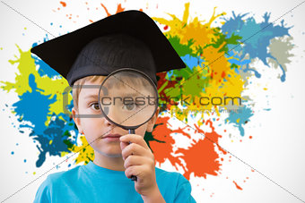 Composite image of cute pupil looking through magnifying glass