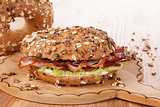 Whole grain bagel with bacon.