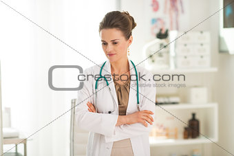 Portrait of thoughtful doctor woman in office