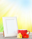 Photo frame with cup of coffee and gerbera flowers