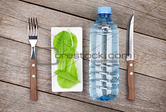 Green salad leaves and water bottle. Healthy food