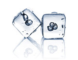 Two melting ice cubes with water dew