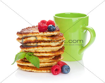 Pancakes with raspberry, blueberry and cup of drink