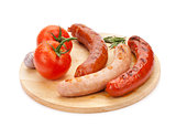 Various grilled sausages and tomatoes