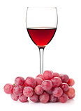Rose wine in glass with red grape branch