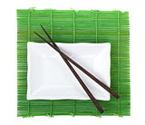 Chopsticks and utensils over bamboo mat