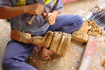 Carving craftsman is carving wood for Buddha model