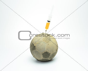 syringe in to the old football isolated