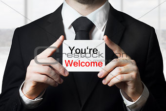 businessman holding sign you are welcome