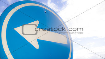 Left Arrow traffic sign with the sky