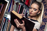 Female student at the library holding a book