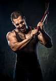 Muscular man holding pickaxe
