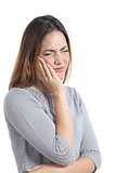 Woman suffering toothache with hand on face
