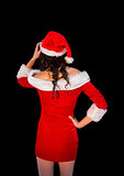 Thinking brunette in santa outfit posing with hand on hip